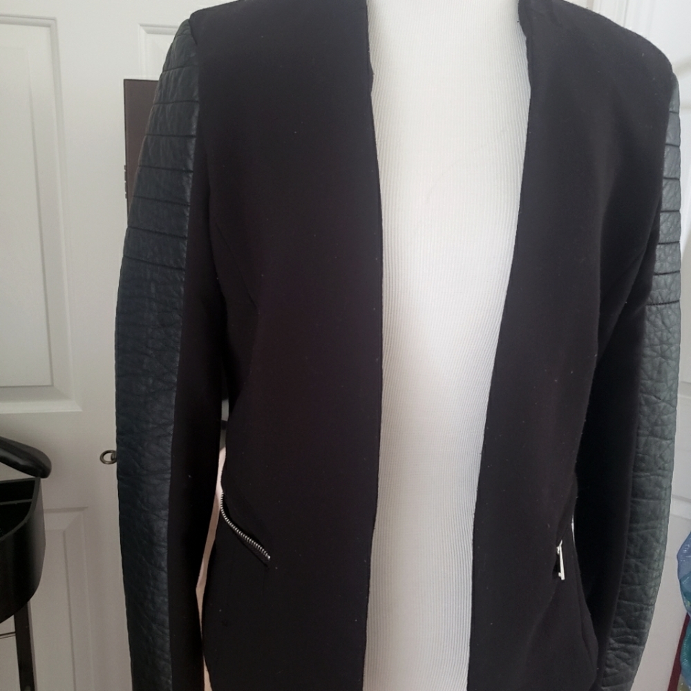 Fitted black blazer, with "leather" sleeves.